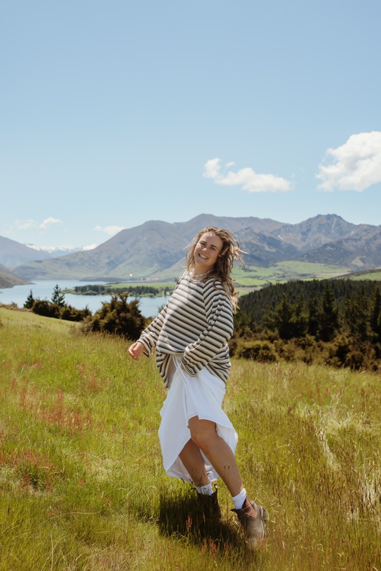 Ebony walking through field with mountains in background — Sydney photographer