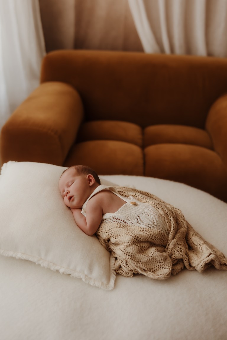 Newborn baby sleeping in soft knit